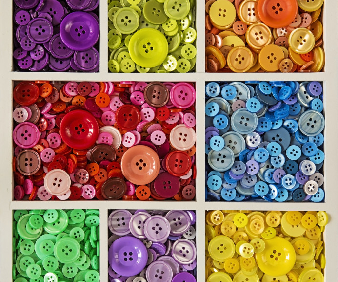 Colorful buttons in the white wooden box