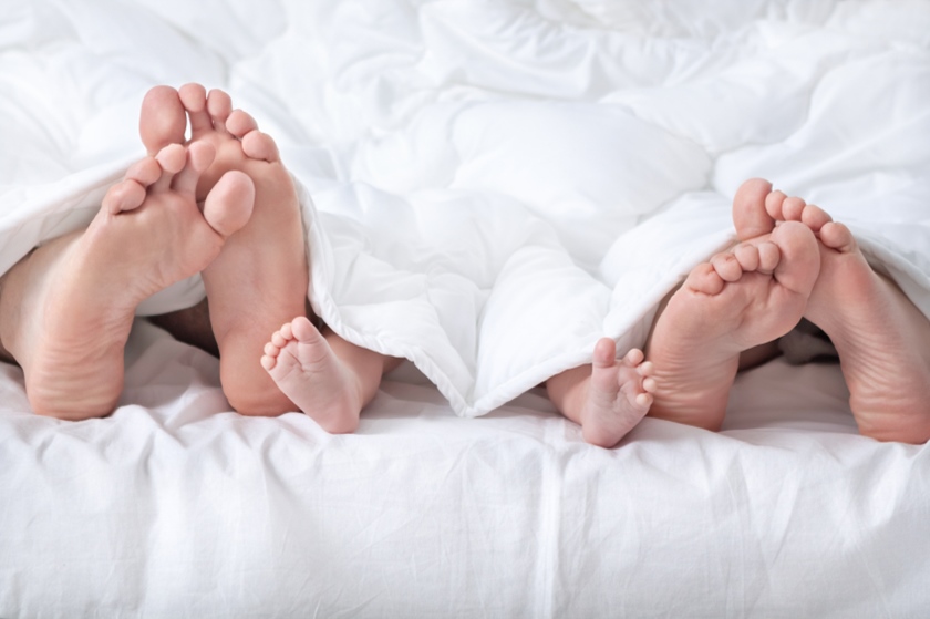 Funny family feet under the blanket